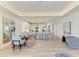 Bright, open-concept kitchen with white cabinets, stainless steel appliances, and a large island with bar seating at 1007 Waterline Ct, Sarasota, FL 34240