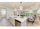 Open-concept kitchen with center island, stainless steel appliances, and stylish pendant lighting at 1007 Waterline Ct, Sarasota, FL 34240