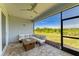 Inviting screened lanai with ample seating, a ceiling fan, and serene outdoor views at 1007 Waterline Ct, Sarasota, FL 34240