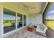 Cozy screened lanai featuring comfortable seating, a ceiling fan, and a beautiful view of the outdoors at 1007 Waterline Ct, Sarasota, FL 34240