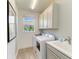 Practical laundry room featuring modern washer, dryer, sink, cabinets, and a window for natural light at 1007 Waterline Ct, Sarasota, FL 34240