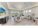 Spacious living room with large sliding glass doors, comfortable seating, and seamless indoor-outdoor flow at 1007 Waterline Ct, Sarasota, FL 34240