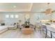 Bright living area and kitchen area showcases modern lighting and seating at 1007 Waterline Ct, Sarasota, FL 34240