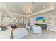 Open-concept living room with ample seating, light wood floors, and access to the kitchen and dining areas at 1007 Waterline Ct, Sarasota, FL 34240