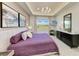 Relaxing main bedroom showcasing a tray ceiling, large windows, and a view of greenery at 1007 Waterline Ct, Sarasota, FL 34240