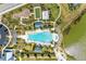 Aerial view of the community pool featuring lounge chairs, umbrellas, palm trees, playground, and recreational area at 1007 Waterline Ct, Sarasota, FL 34240