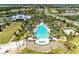 Overhead shot of a community pool with chairs, palm trees, cabanas, and green grass in a well-planned community at 1007 Waterline Ct, Sarasota, FL 34240