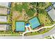 Birds eye view of two community tennis courts showcasing the nets, the green playing surface, and surrounding community at 1007 Waterline Ct, Sarasota, FL 34240