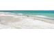 Scenic beach view featuring turquoise waters, white sands, and birds on the shoreline at 101 25Th N St # 1, Bradenton Beach, FL 34217