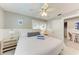 Bright bedroom featuring a ceiling fan, bedside tables, and a cozy seating area, offering a relaxing retreat at 101 25Th N St # 1, Bradenton Beach, FL 34217