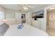 Comfortable bedroom with a ceiling fan and TV, alongside a small desk area, perfect for relaxation and productivity at 101 25Th N St # 1, Bradenton Beach, FL 34217