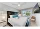 Bright bedroom featuring a large window, a ceiling fan, and a cozy seating area, offering a relaxing retreat at 101 25Th N St # 1, Bradenton Beach, FL 34217