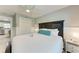 Inviting bedroom featuring a ceiling fan, bedside tables, and a peek into the kitchen at 101 25Th N St # 1, Bradenton Beach, FL 34217