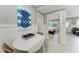 Coastal dining area with a white table, seating for two, and a bedroom view at 101 25Th N St # 1, Bradenton Beach, FL 34217