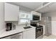 Modern kitchen with stainless steel appliances, white countertops, and ample cabinet space at 101 25Th N St # 1, Bradenton Beach, FL 34217