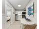 Charming kitchen and dining area with sleek appliances, and an adjacent cozy bedroom at 101 25Th N St # 1, Bradenton Beach, FL 34217