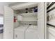 Convenient laundry closet with washer, dryer, and storage shelves, adding practicality to the home at 101 25Th N St # 1, Bradenton Beach, FL 34217