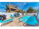 Inviting backyard pool area with blue lounge chairs and shade umbrellas at 101 25Th N St # 1, Bradenton Beach, FL 34217