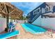 Sparkling backyard pool is surrounded by ample seating and a privacy fence at 101 25Th N St # 1, Bradenton Beach, FL 34217