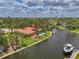 Beautiful waterfront home with a private pool, dock, and lush landscaping, situated on a scenic canal at 1038 Contento St, Sarasota, FL 34242