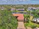 Stunning aerial view of waterfront home with red tile roof along a tranquil canal at 1038 Contento St, Sarasota, FL 34242