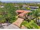 Aerial shot of a waterfront property featuring a red-tiled roof and lush landscaping at 1038 Contento St, Sarasota, FL 34242
