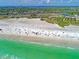 Bustling beach with white sand, turquoise water, and a vibrant cityscape in the background on Siesta Key at 1038 Contento St, Sarasota, FL 34242
