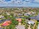 Scenic aerial view of waterfront property nestled amongst lush trees and a winding canal at 1038 Contento St, Sarasota, FL 34242