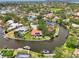 Aerial view of a waterfront community with lush tropical landscaping, private boat docks, pool, and canal access at 1038 Contento St, Sarasota, FL 34242