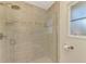 Walk in shower with glass door and neutral tiles at 1038 Contento St, Sarasota, FL 34242