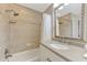 Bathroom featuring tiled tub/shower combo, decorative mirror and single sink vanity at 1038 Contento St, Sarasota, FL 34242