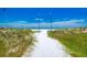 Beautiful sandy beach with lush dunes leading to the serene ocean at 1038 Contento St, Sarasota, FL 34242