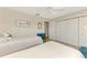 Bedroom with two twin beds, light walls, ceiling fan and double door closet at 1038 Contento St, Sarasota, FL 34242