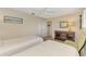 Bedroom with two twin beds, light walls, ceiling fan and chest of drawers at 1038 Contento St, Sarasota, FL 34242