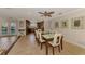 Dining area open to the kitchen and patio, featuring tile flooring and a coastal decor theme at 1038 Contento St, Sarasota, FL 34242