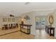 Inviting entryway leading to a dining area and featuring decorative console tables and tiled flooring at 1038 Contento St, Sarasota, FL 34242