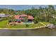 Inviting home with a stunning waterfront view, complemented by a pool, solar panels, and outdoor seating area at 1038 Contento St, Sarasota, FL 34242
