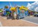 Quaint mini donut shop with a cheerful, beach-themed design and ample signage at 1038 Contento St, Sarasota, FL 34242