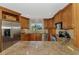 Gourmet kitchen with granite countertops, wood cabinetry, and stainless steel appliances at 1038 Contento St, Sarasota, FL 34242