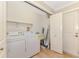 Bright laundry room with washer, dryer, wash sink, and shelving at 1038 Contento St, Sarasota, FL 34242
