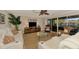 Bright living area features comfortable seating, stylish décor, and sliding doors with tranquil water views at 1038 Contento St, Sarasota, FL 34242