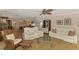 Bright living room featuring white leather seating, a ceiling fan, and a glass coffee table at 1038 Contento St, Sarasota, FL 34242