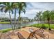 Relaxing waterfront lounge chairs on a brick patio offering stunning views and a peaceful outdoor retreat at 1038 Contento St, Sarasota, FL 34242