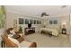 This bedroom features a ceiling fan, wood floors, and natural light at 1038 Contento St, Sarasota, FL 34242