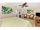 Spacious bedroom features ceiling fan, wood floors, and natural light at 1038 Contento St, Sarasota, FL 34242
