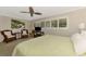 Spacious bedroom with sitting area, wood floors, ceiling fan and large windows at 1038 Contento St, Sarasota, FL 34242