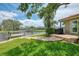 Waterfront patio and outdoor grill area with lush green lawn and water access under a sunny, partly cloudy sky at 1038 Contento St, Sarasota, FL 34242