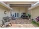 Inviting brick patio with comfortable seating, plants, and dining space, perfect for outdoor relaxation and entertaining at 1038 Contento St, Sarasota, FL 34242