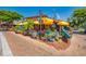 Vibrant restaurant exterior with colorful umbrellas and lush greenery, creating a lively and inviting atmosphere for dining at 1038 Contento St, Sarasota, FL 34242