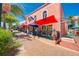 Captivating cafe exterior with inviting sidewalk seating, colorful umbrellas, and charming details, a local hot spot at 1038 Contento St, Sarasota, FL 34242